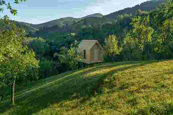 MuMA Hut: un eco tiny house de 16 metri pătrați ridicat între dealuri, de unde te uiți în livadă și vezi zimbri